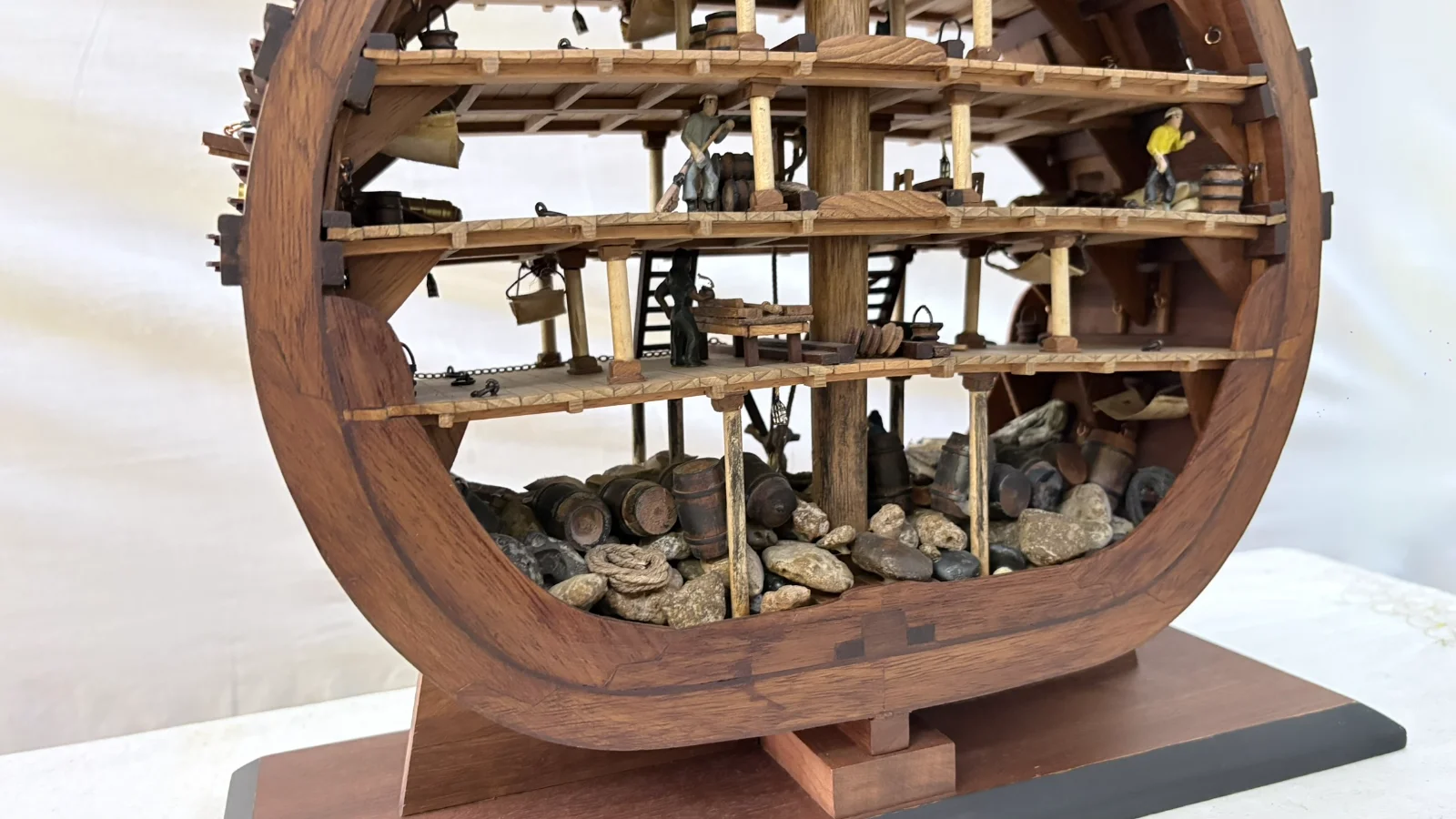 Handcrafted wooden ship model cross section showing detailed internal decks and framing