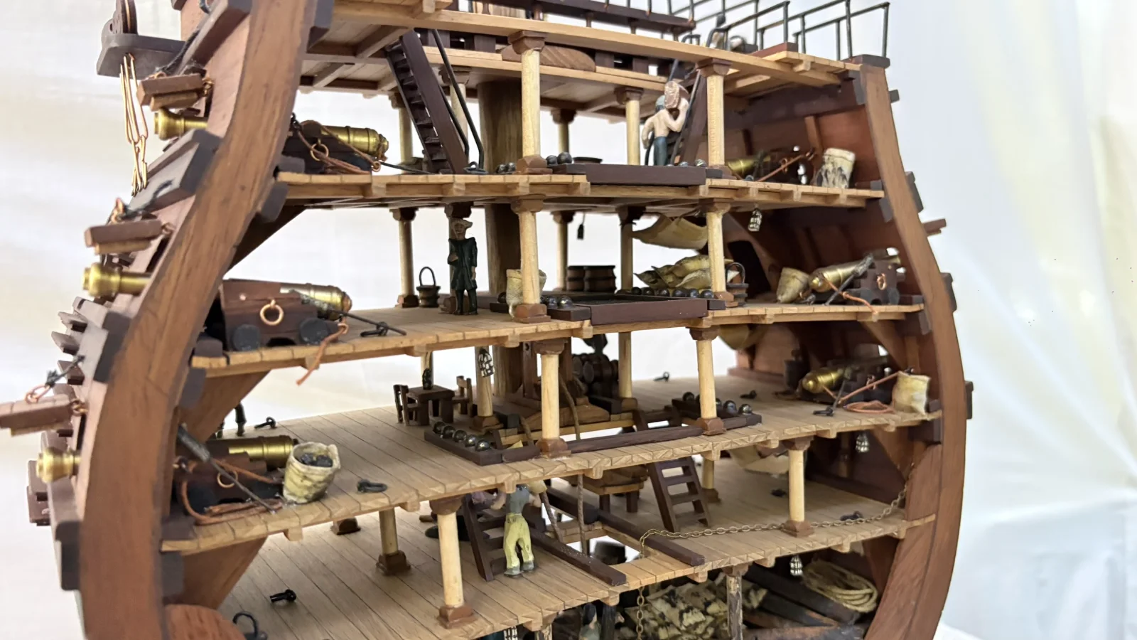 Handcrafted wooden ship model cross section showing detailed internal decks and framing
