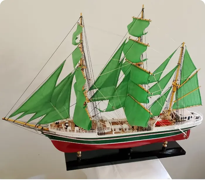 Handcrafted historical wooden scale model ship of the German tall ship Alexander von Humboldt II with full emerald green sails.