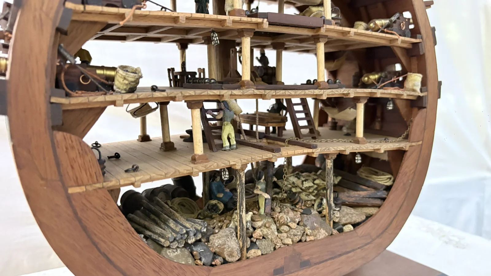 Handcrafted wooden ship model cross section showing detailed internal decks and framing