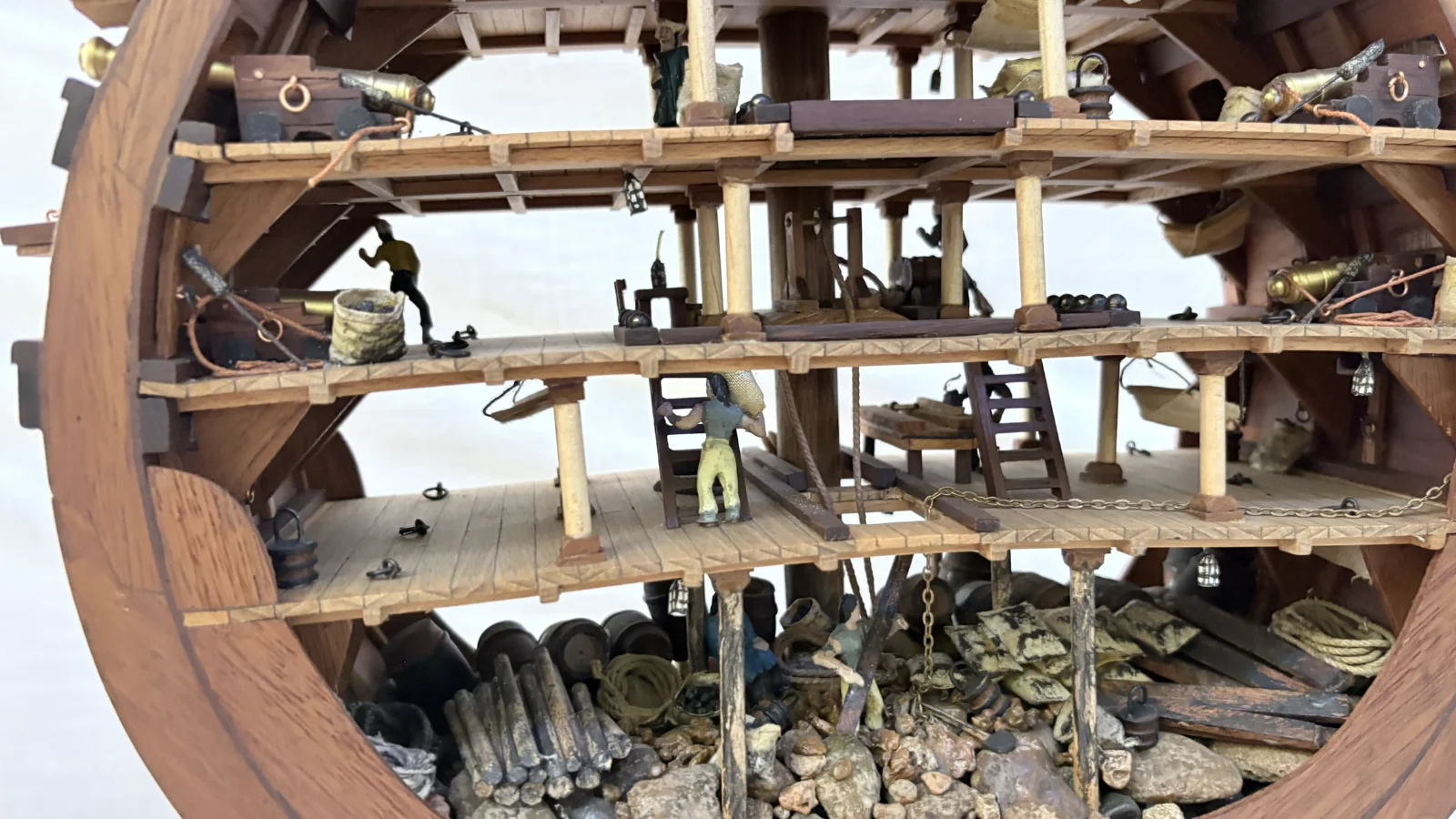 Handcrafted wooden ship model cross section showing detailed internal decks and framing
