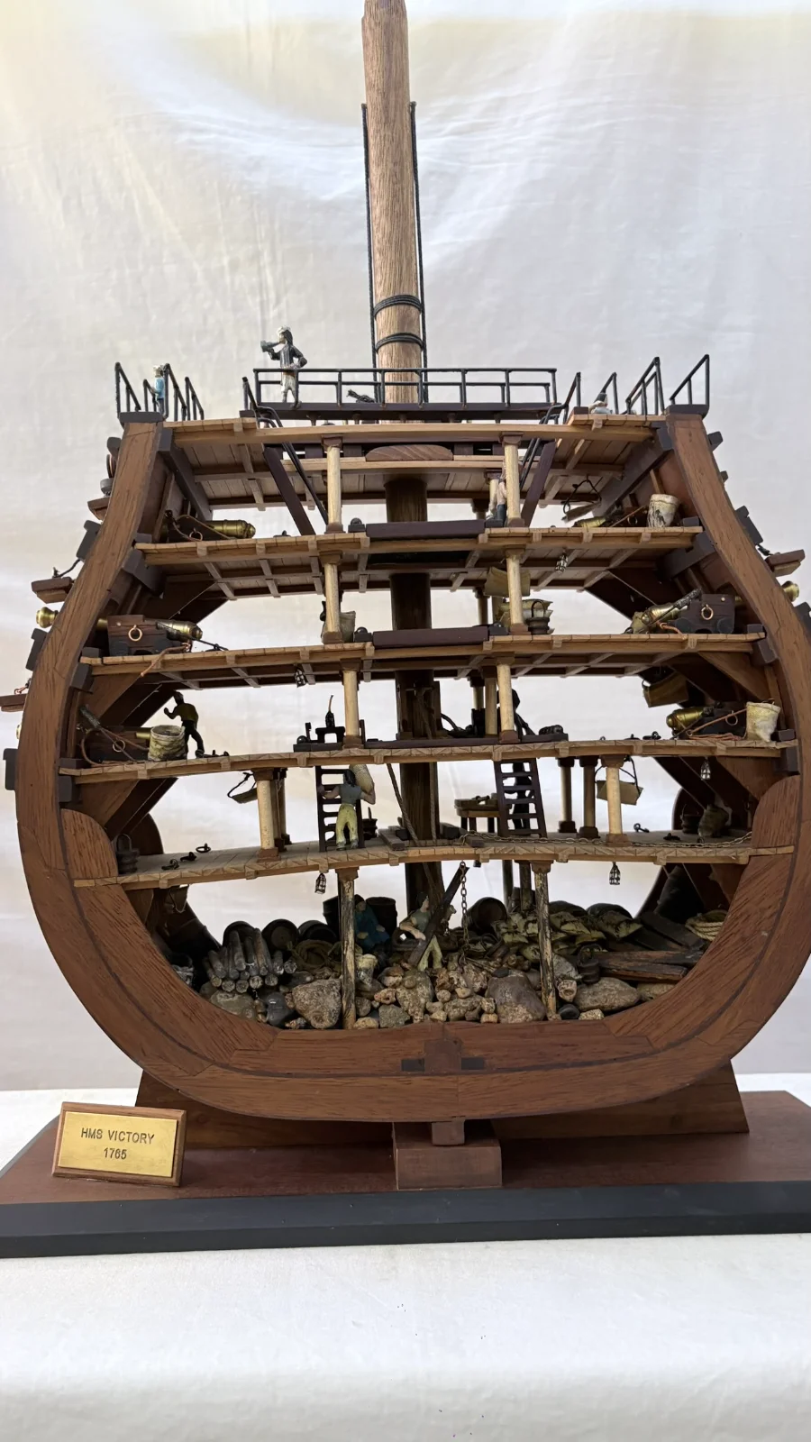 Handcrafted wooden ship model cross section showing detailed internal decks and framing