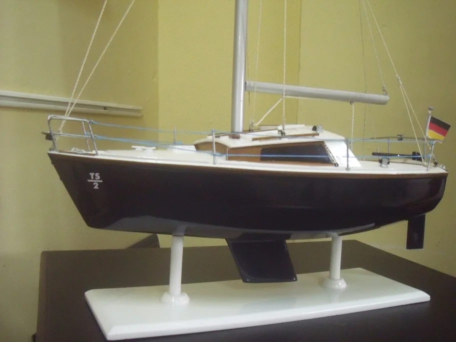 Artisan custom handcrafted wooden model ship of the classic lapstrake hull Waarschip sailing boat on a wooden display stand.