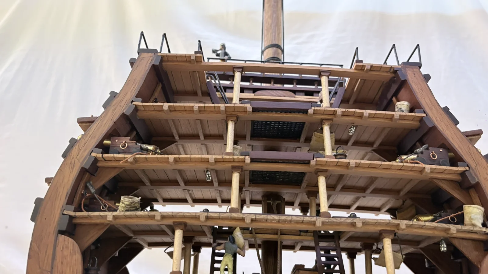 Handcrafted wooden ship model cross section showing detailed internal decks and framing