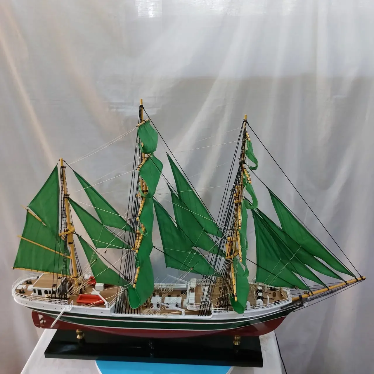 Handcrafted historical wooden scale model ship of the German tall ship Alexander von Humboldt II with full emerald green sails.