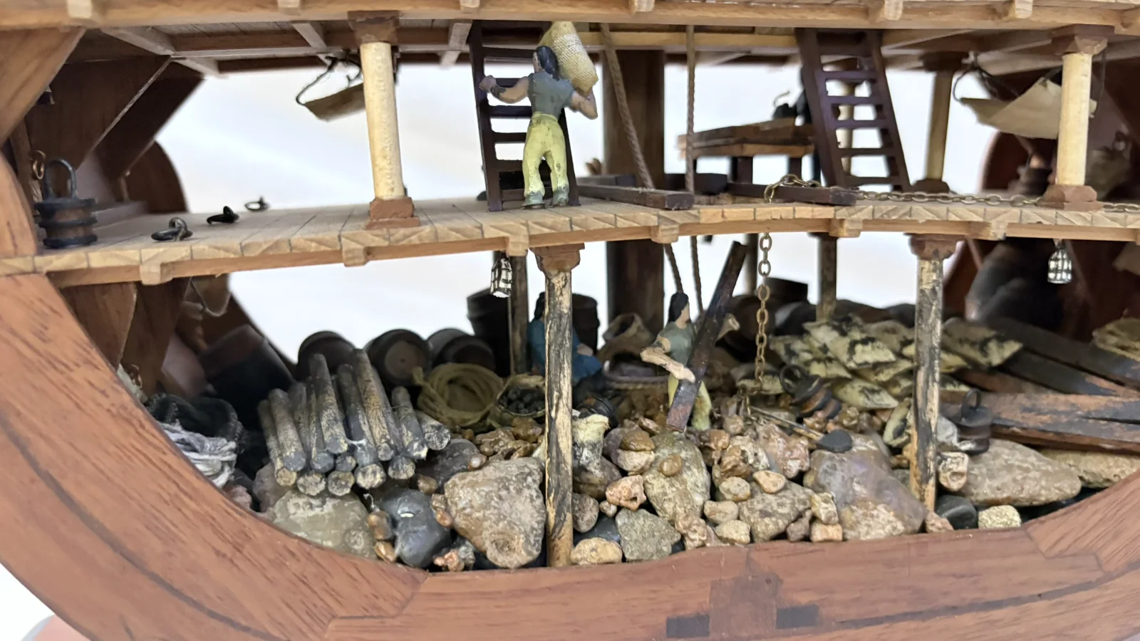 Handcrafted wooden ship model cross section showing detailed internal decks and framing