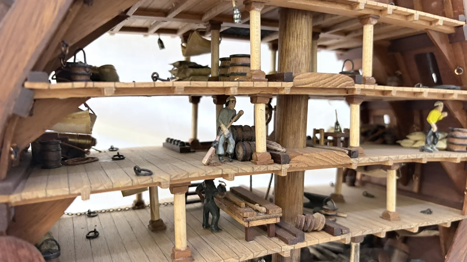Handcrafted wooden ship model cross section showing detailed internal decks and framing
