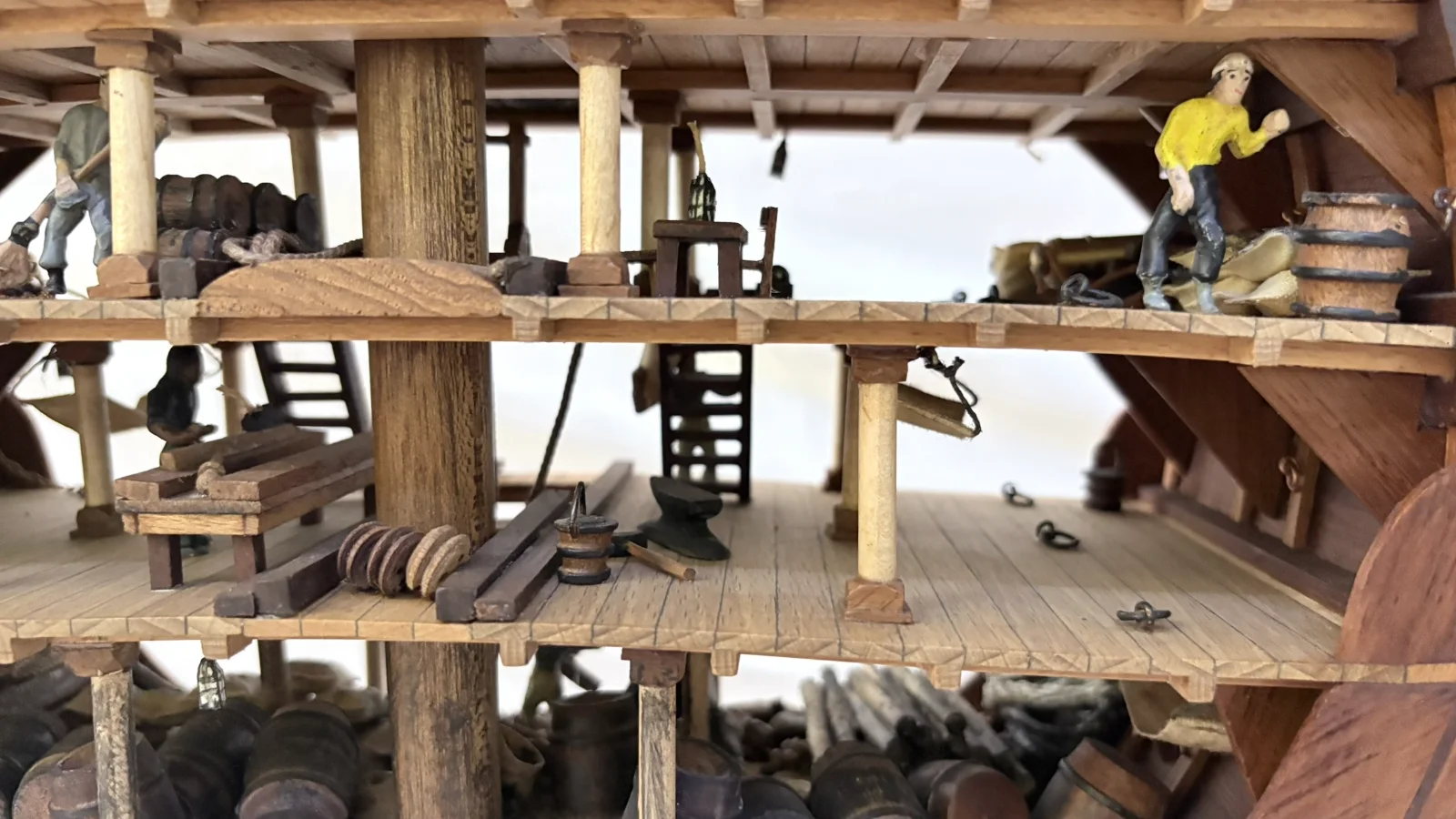 Handcrafted wooden ship model cross section showing detailed internal decks and framing