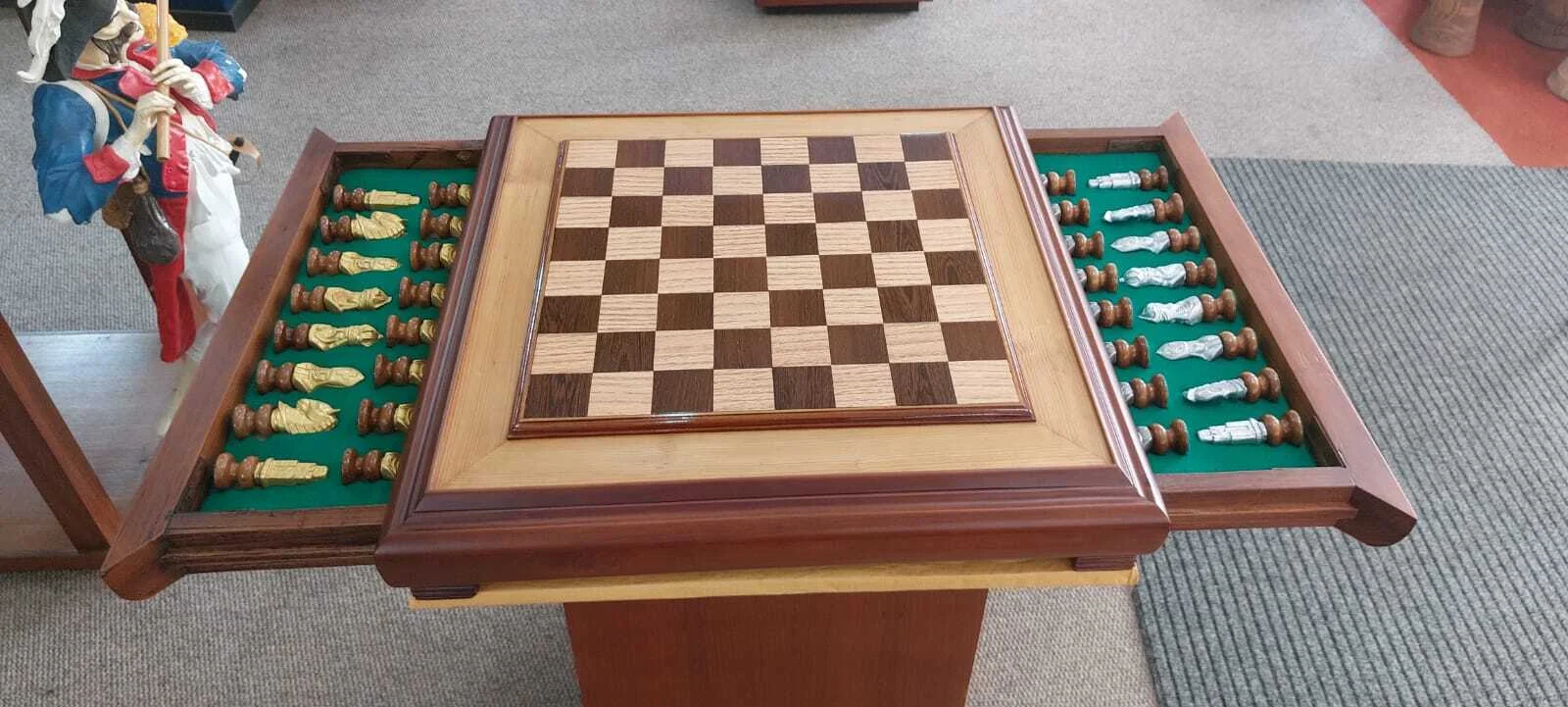 Premium handcrafted wooden chess table with metallic gold and silver pieces, showcasing open storage drawers with green felt lining.