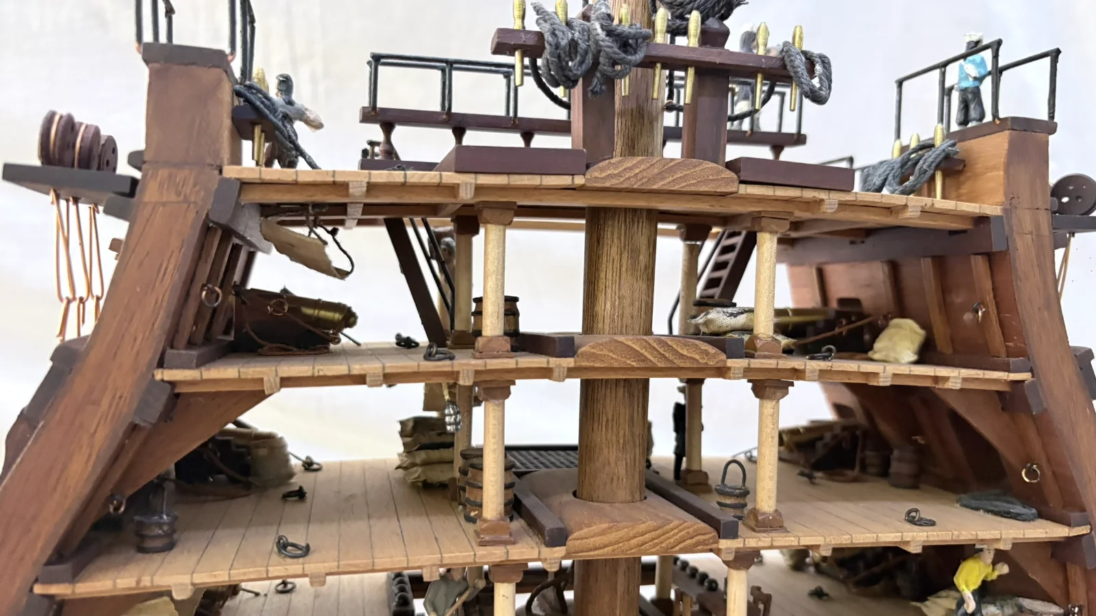 Handcrafted wooden ship model cross section showing detailed internal decks and framing