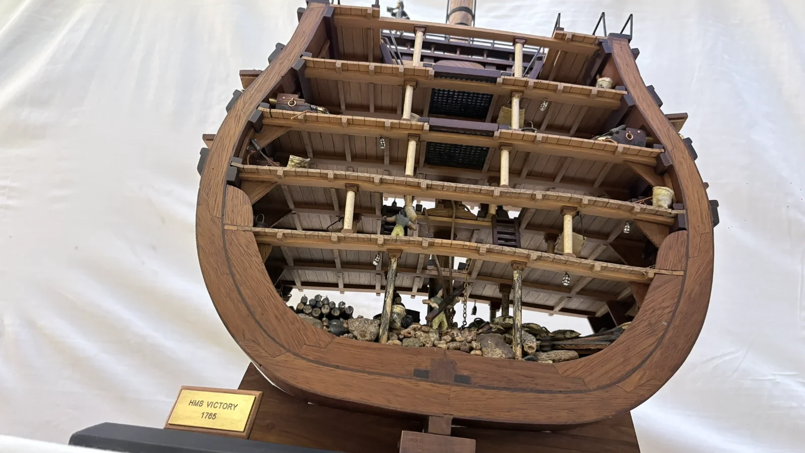 Handcrafted wooden ship model cross section showing detailed internal decks and framing