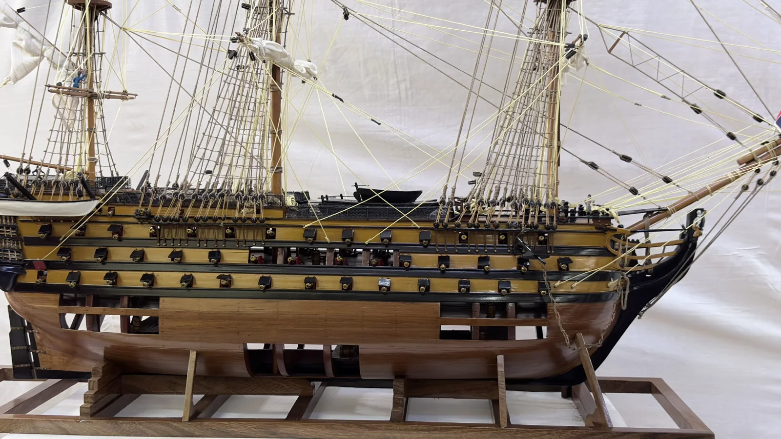 Large handcrafted 1m 35cm wooden HMS Victory ship model with cutaway hull revealing interior decks