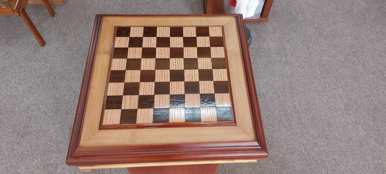 Premium handcrafted wooden chess table with metallic gold and silver pieces, showcasing open storage drawers with green felt lining.
