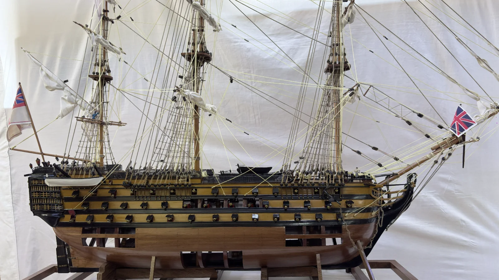 Large handcrafted 1m 35cm wooden HMS Victory ship model with cutaway hull revealing interior decks