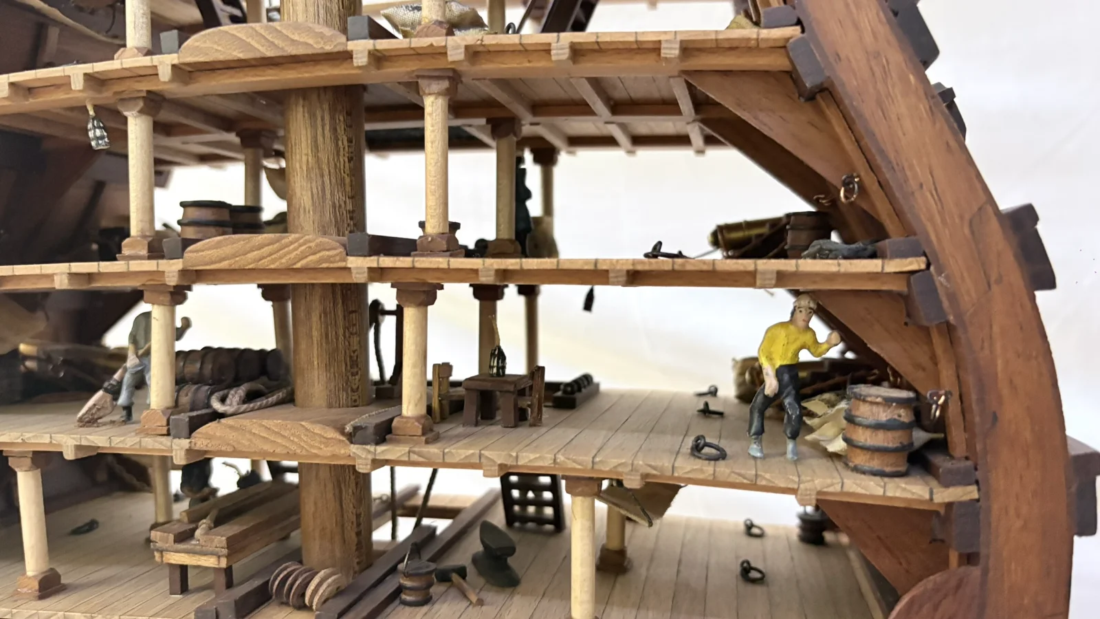 Handcrafted wooden ship model cross section showing detailed internal decks and framing
