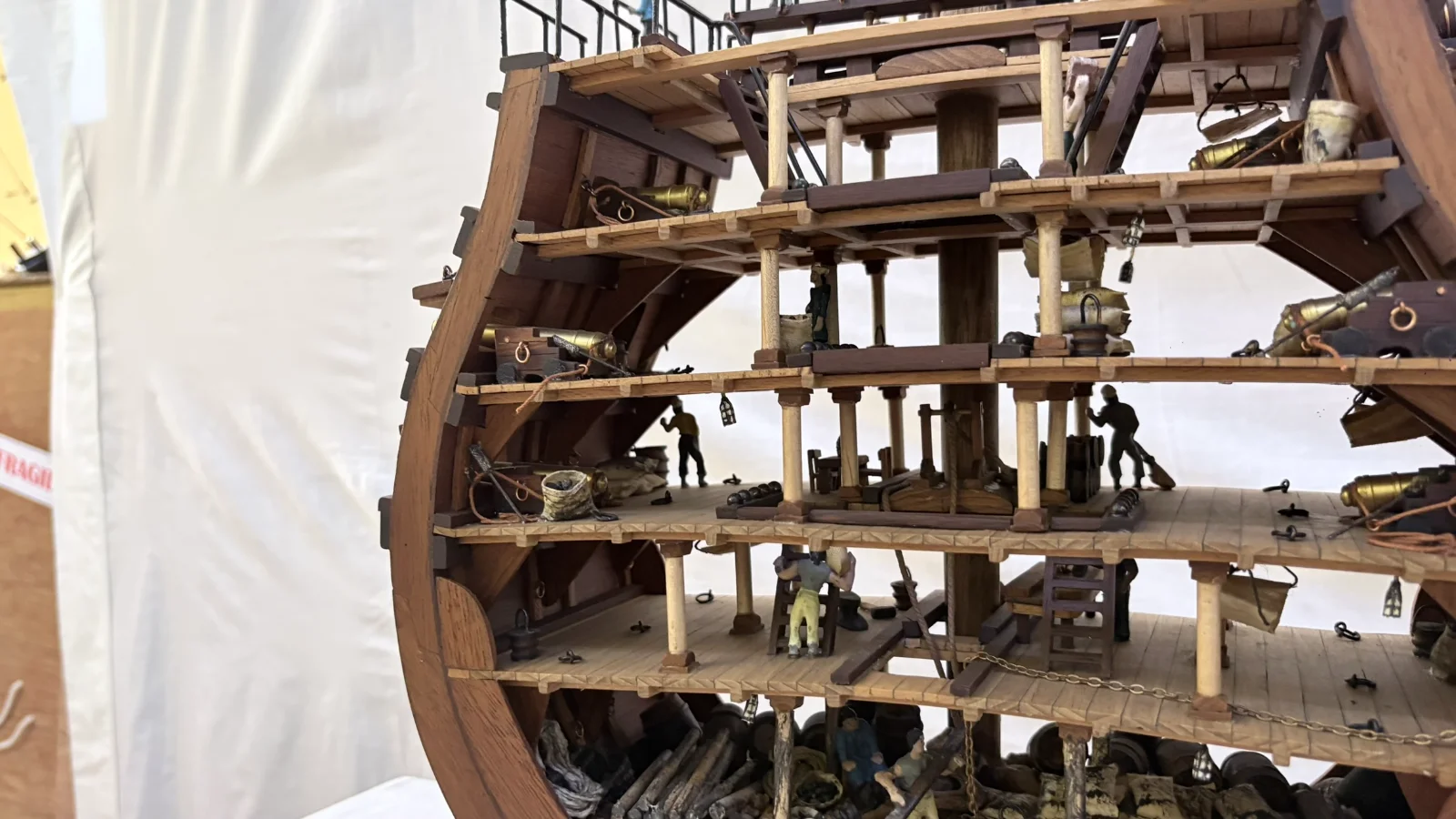 Handcrafted wooden ship model cross section showing detailed internal decks and framing