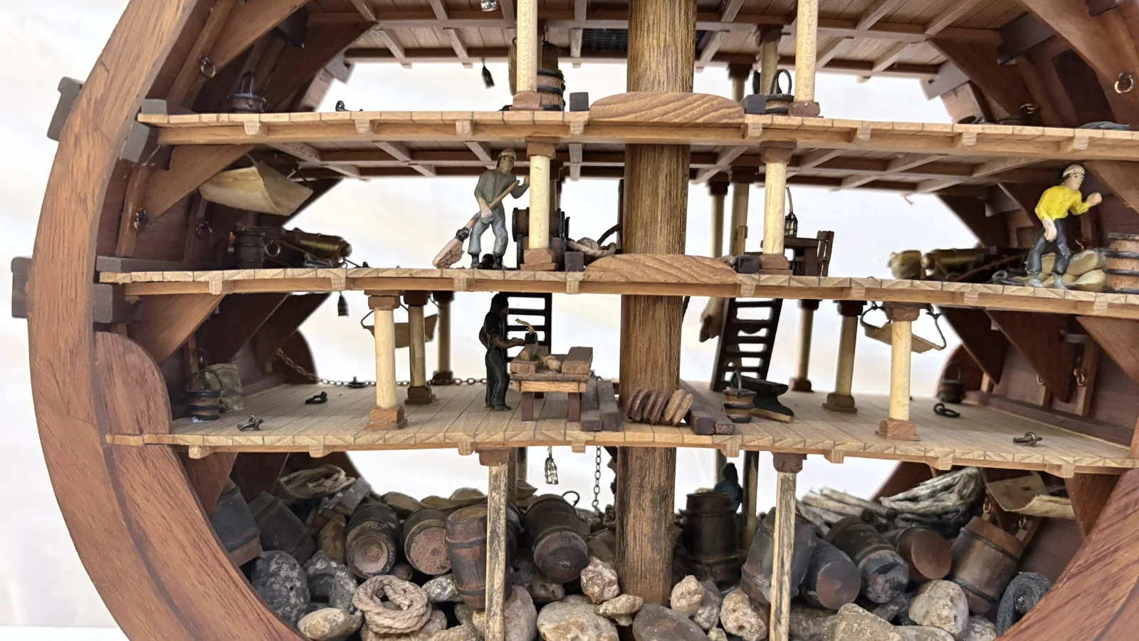 Handcrafted wooden ship model cross section showing detailed internal decks and framing