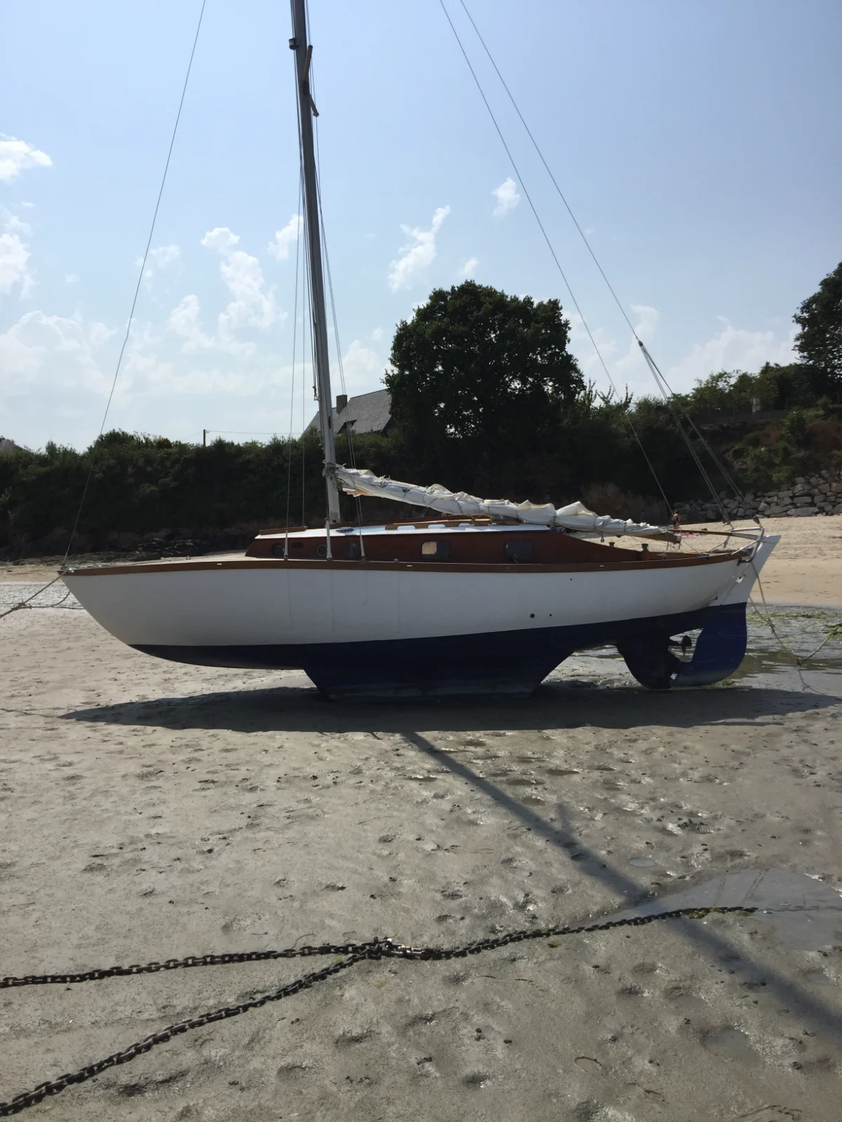 Custom handcrafted wooden scale model of the Argo class sailboat on a protective presentation baseboard.