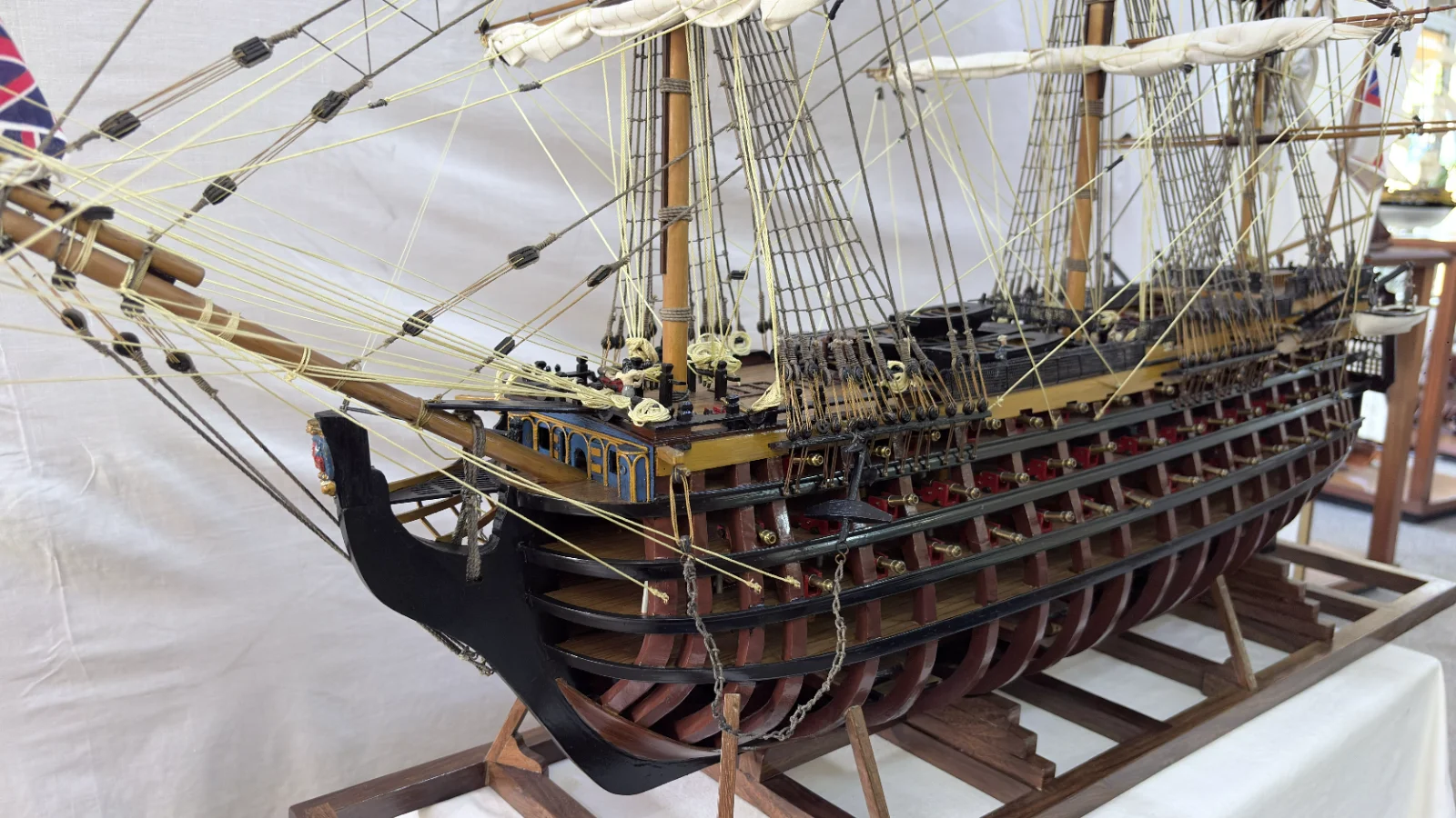 Large handcrafted 1m 35cm wooden HMS Victory ship model with cutaway hull revealing interior decks