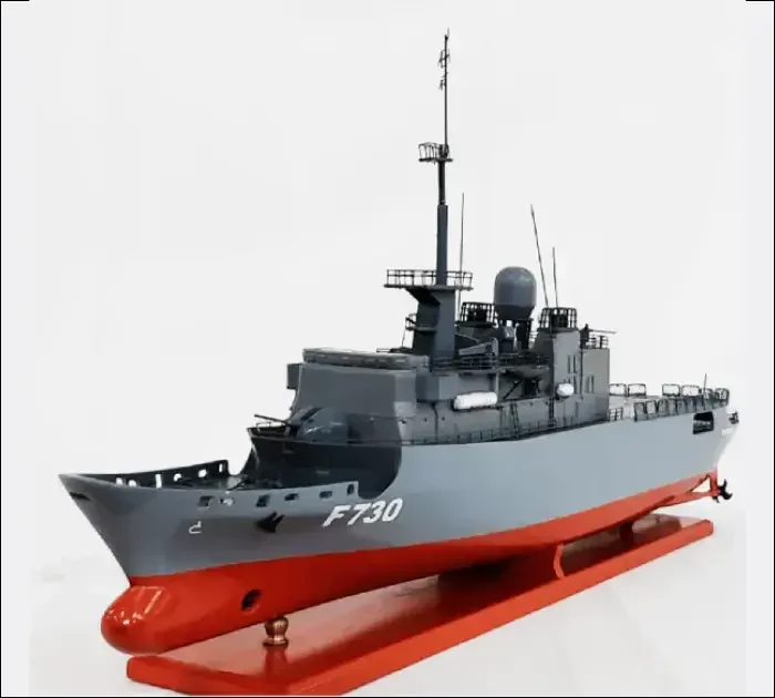 Custom handcrafted wooden military model ship of the French Navy Frigate Floréal on polished brass supports.