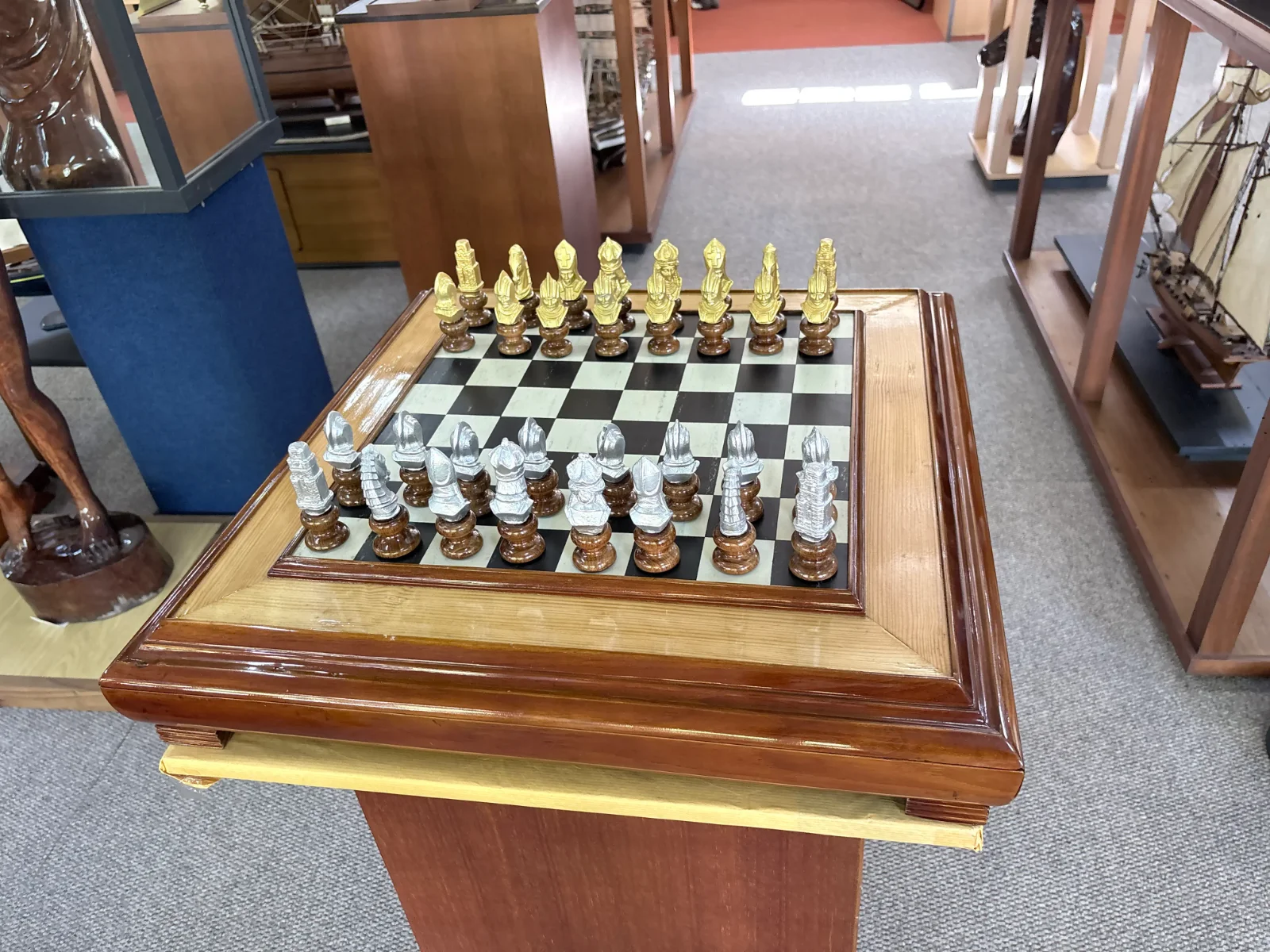 Premium handcrafted wooden chess table with metallic gold and silver pieces, showcasing open storage drawers with green felt lining.