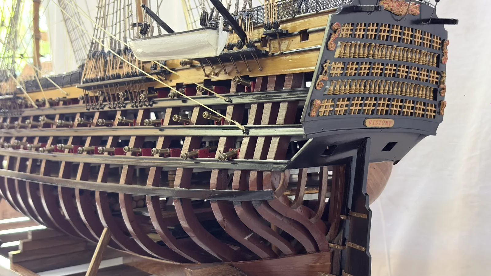 Large handcrafted 1m 35cm wooden HMS Victory ship model with cutaway hull revealing interior decks