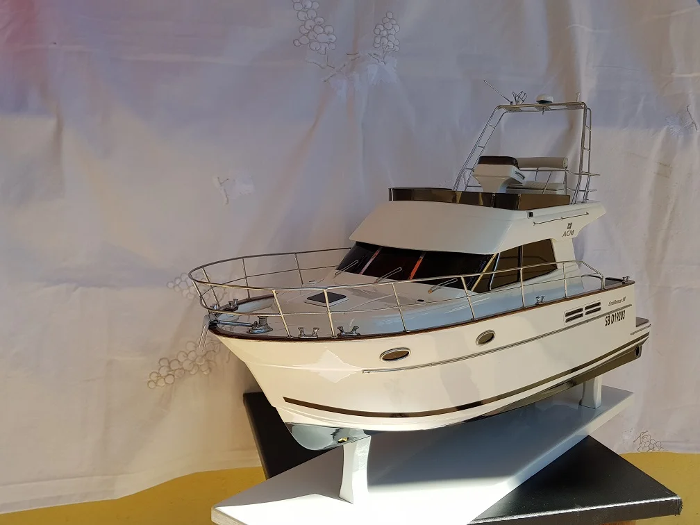 Custom handcrafted wooden model of the ACM Excellent luxury motor yacht with polished finish on a wooden display stand.