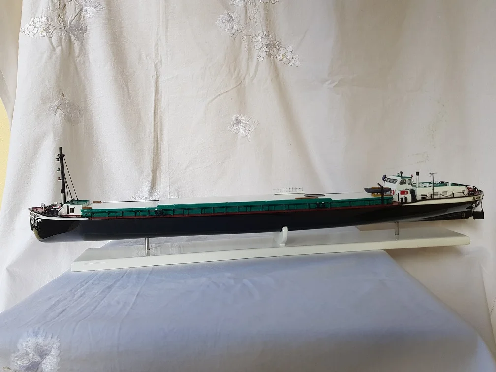 High-end handcrafted wooden sailboat model of the Blueprint Brussow on a minimalist presentation stand.
