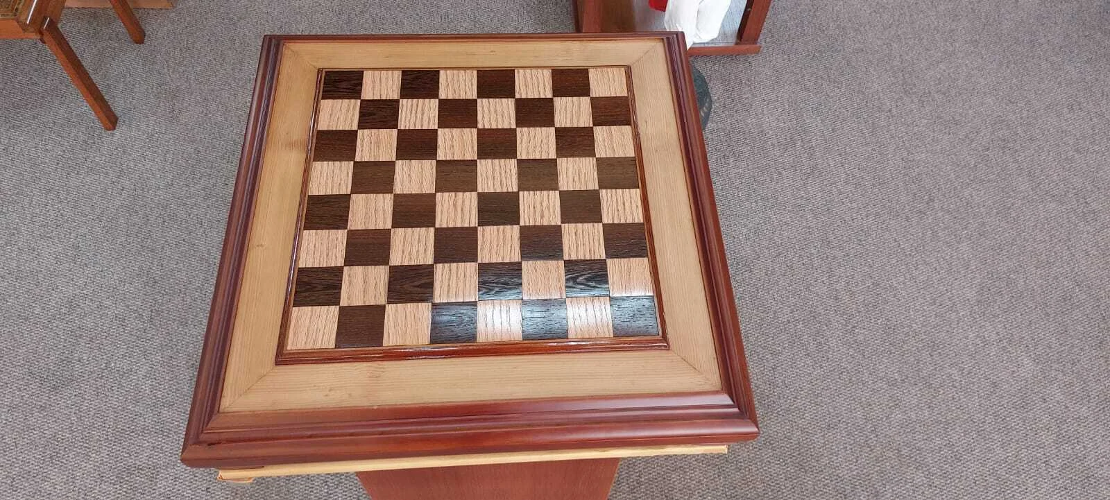 Premium handcrafted wooden chess table with metallic gold and silver pieces, showcasing open storage drawers with green felt lining.