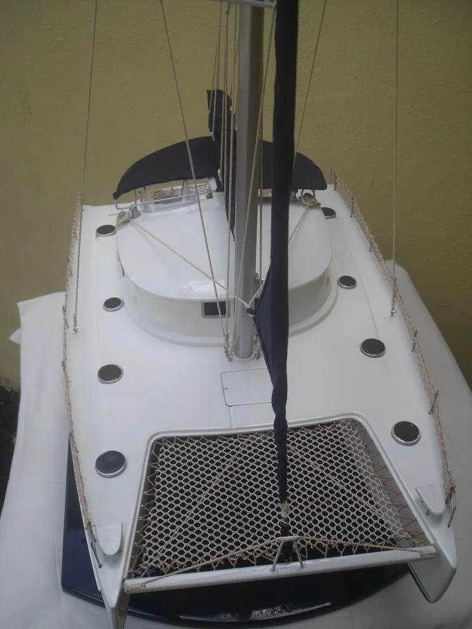 Handcrafted scale wooden model of the Belize 43 sailing catamaran with full fabric rigging on a premium display base.