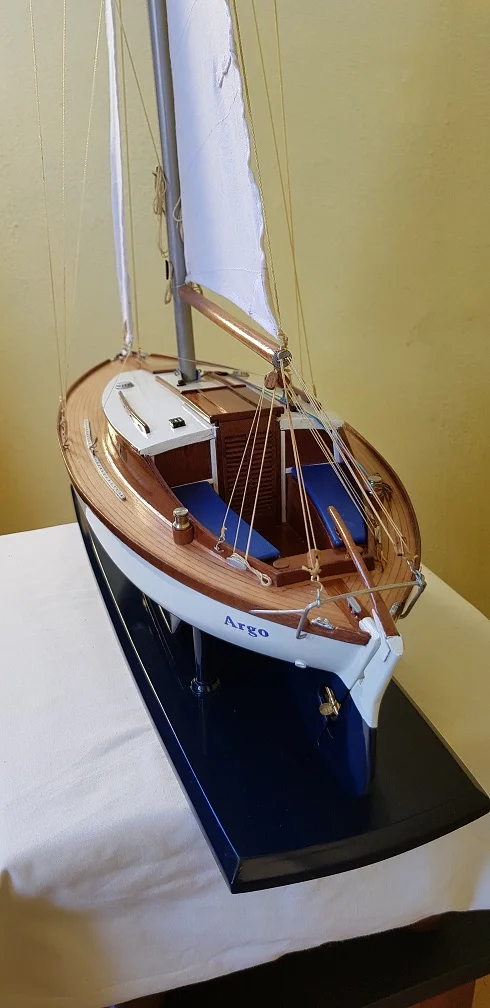 Custom handcrafted wooden scale model of the Argo class sailboat on a protective presentation baseboard.