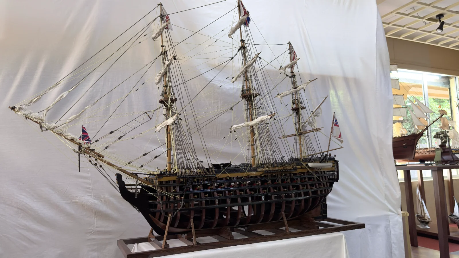 Large handcrafted 1m 35cm wooden HMS Victory ship model with cutaway hull revealing interior decks