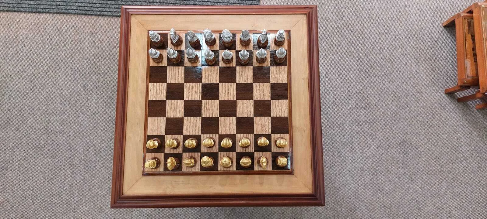 Premium handcrafted wooden chess table with metallic gold and silver pieces, showcasing open storage drawers with green felt lining.