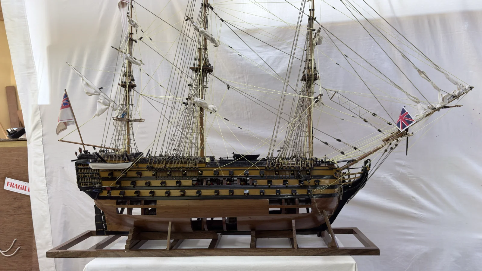 Large handcrafted 1m 35cm wooden HMS Victory ship model with cutaway hull revealing interior decks