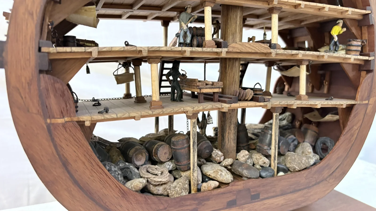 Handcrafted wooden ship model cross section showing detailed internal decks and framing