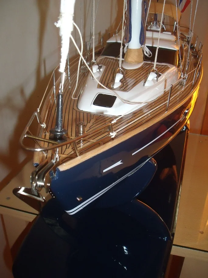 Handcrafted wooden model ship of the Macado sailing cruiser with fully deployed sails and detailed deck rigging.